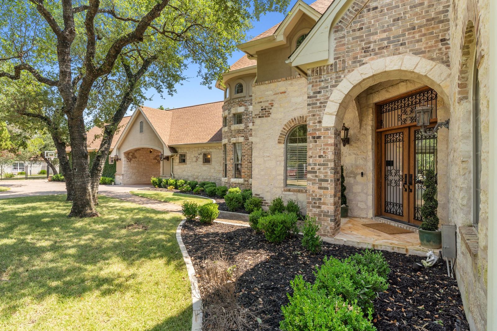 Arched entry with wrought-iron doors