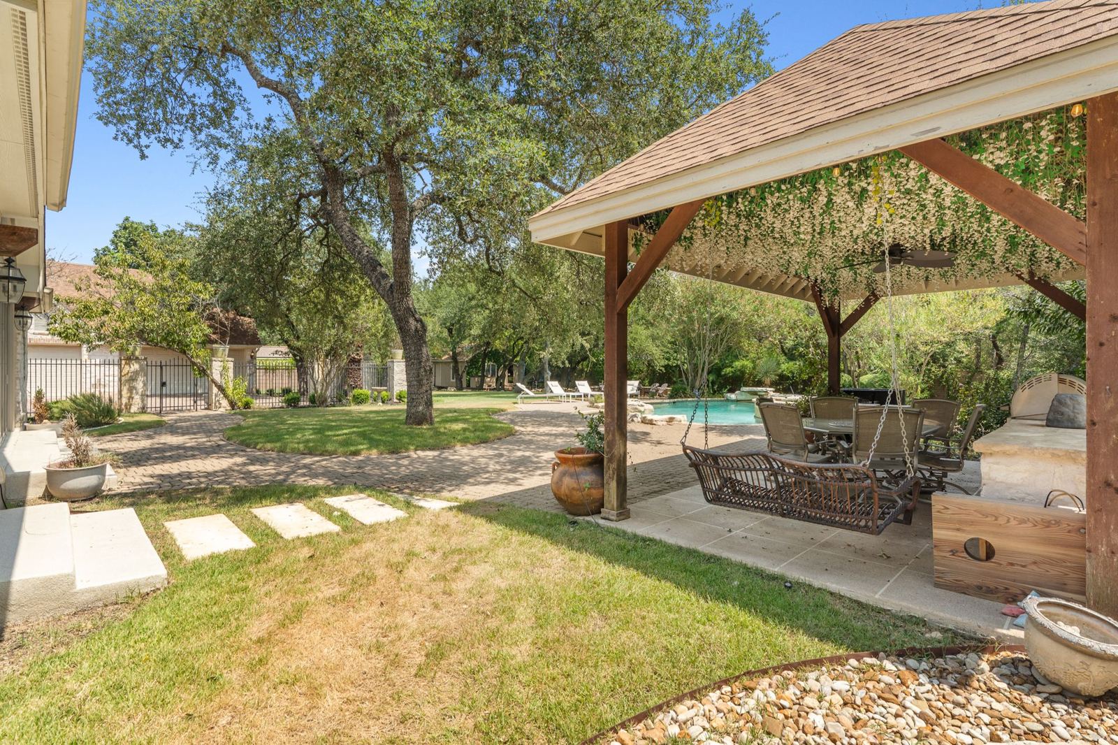 Cedar cabana with hanging swing chair and lounge seating