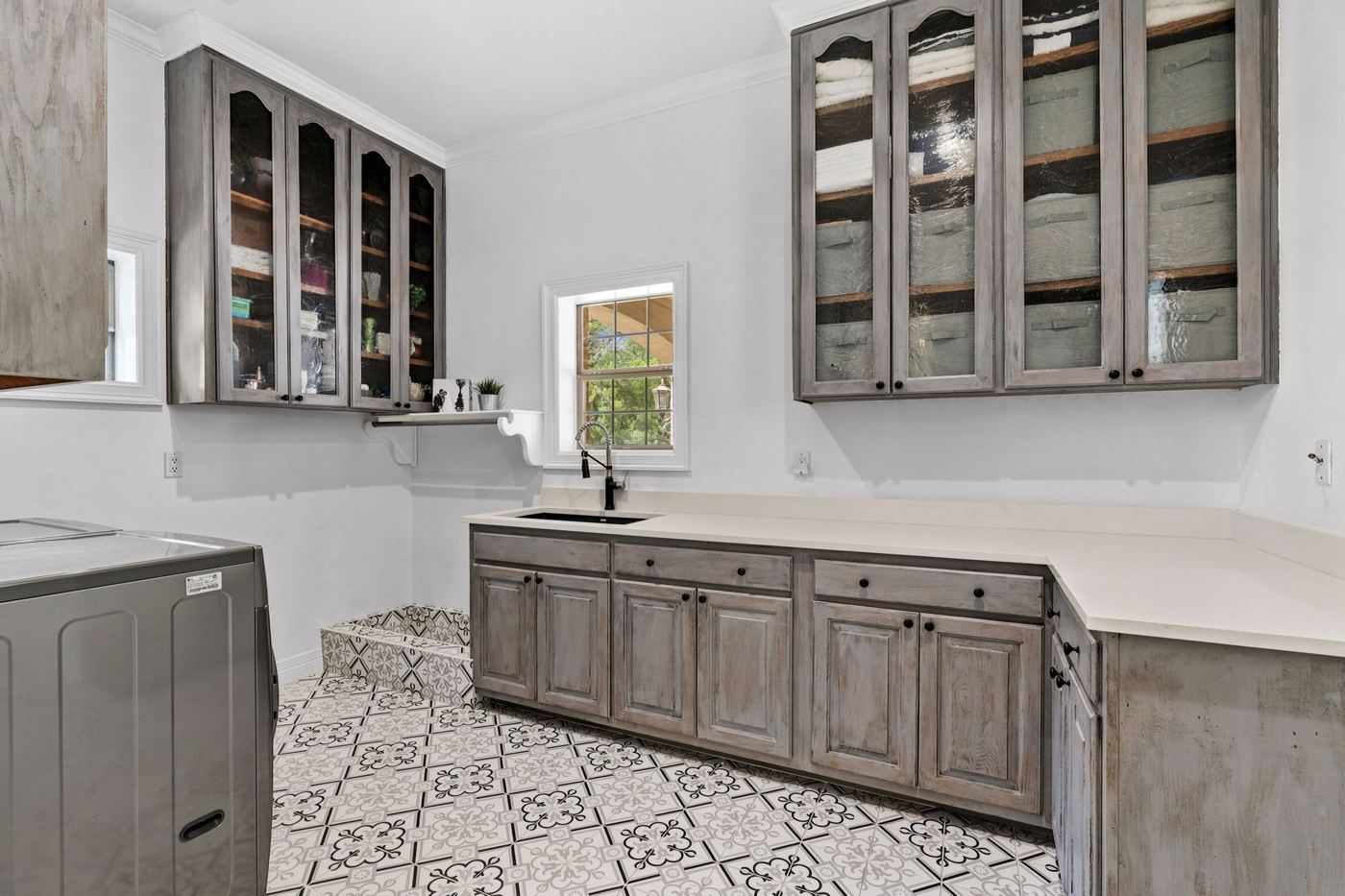 Laundry room with patterned tile floor