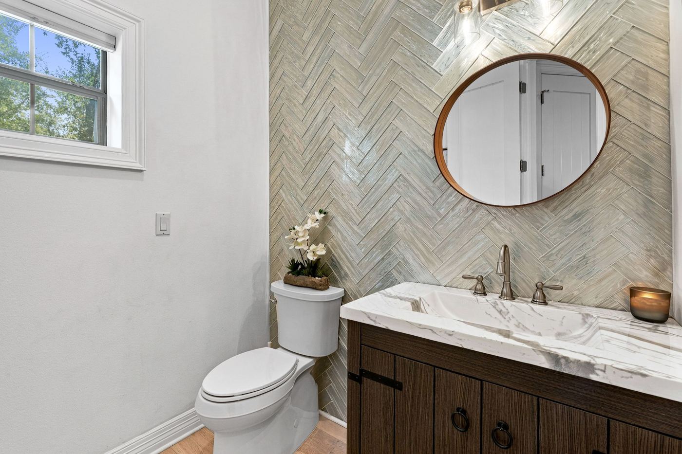 Powder room with herringbone tile wall