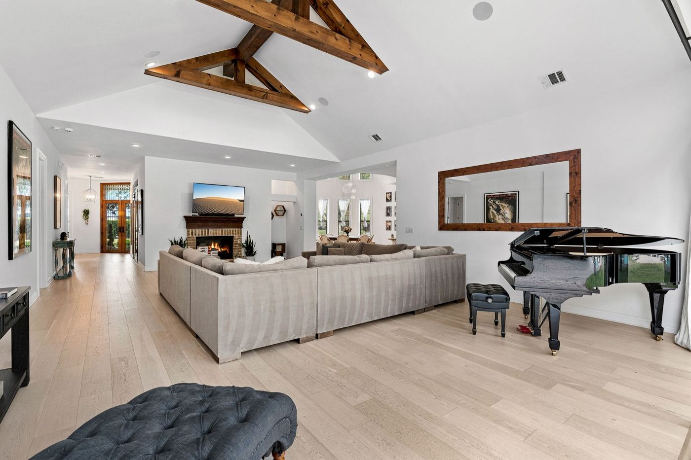 Great room with grand piano and fireplace