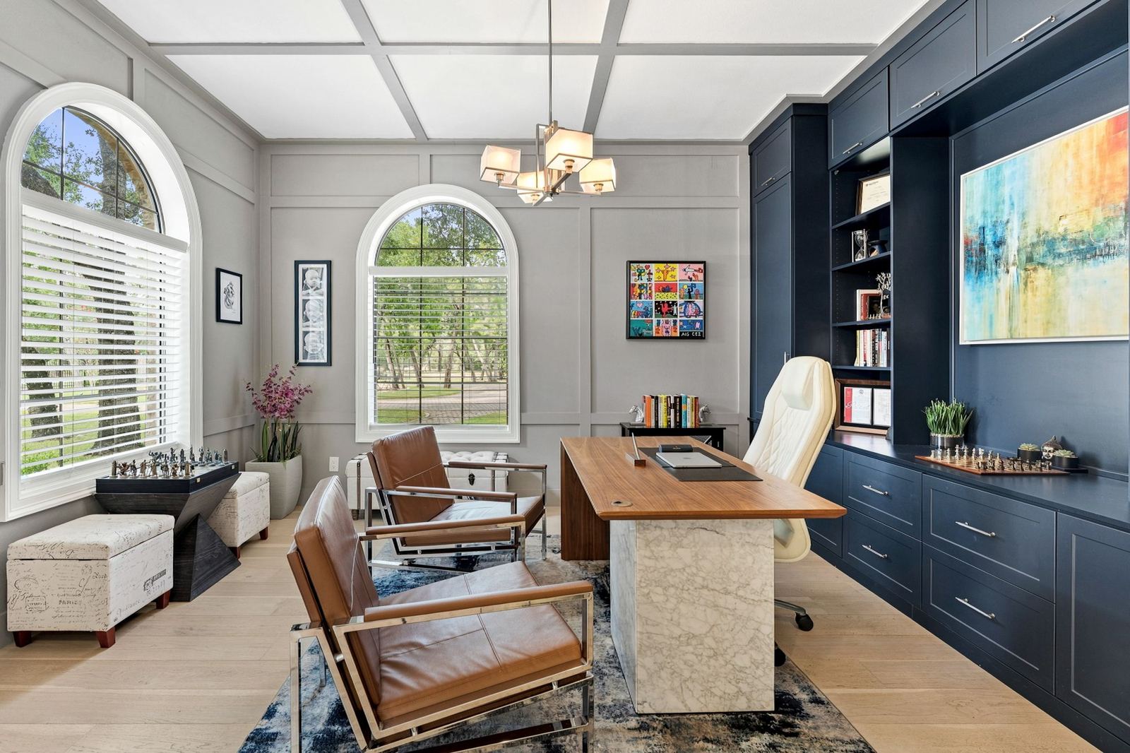 Library office with navy built-ins and arched windows