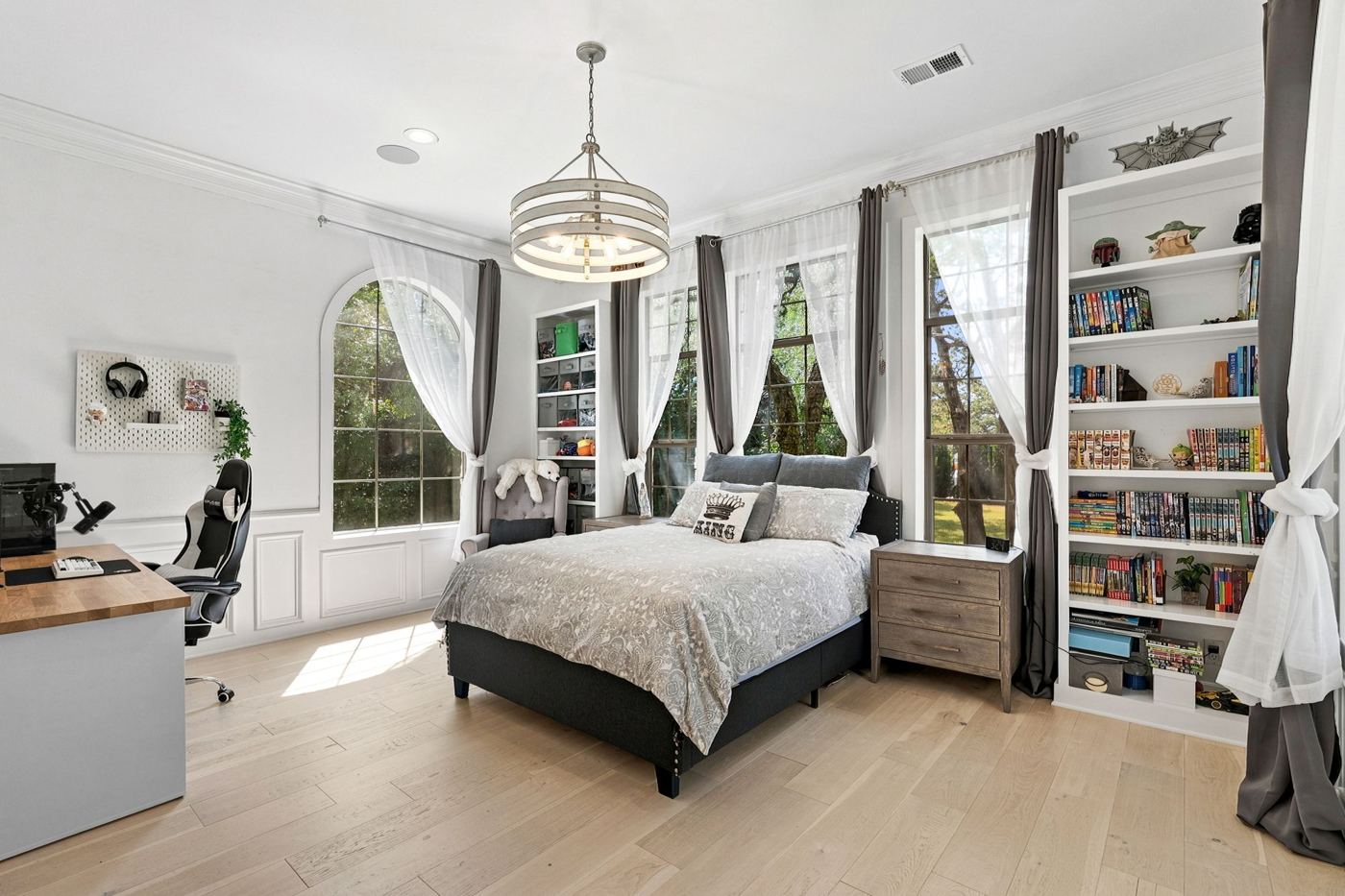 Bedroom with arched windows and bookshelves