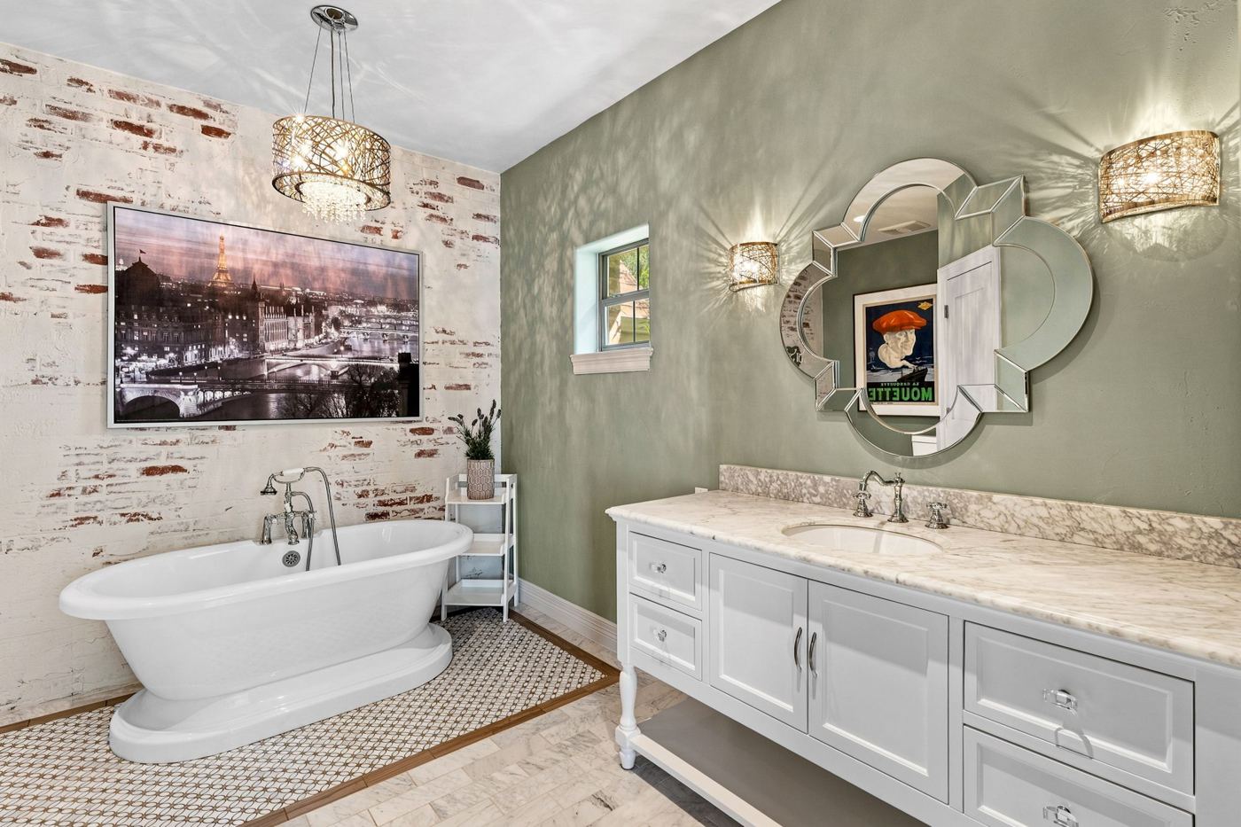 Bath with clawfoot tub, sage wall and crystal sconces
