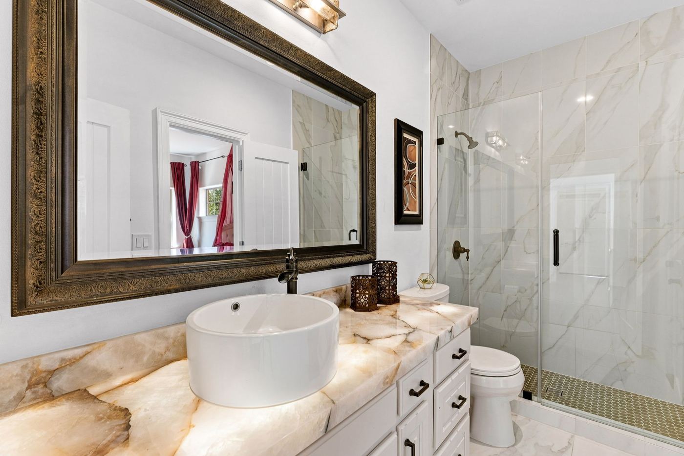 Bath with onyx vanity and marble shower